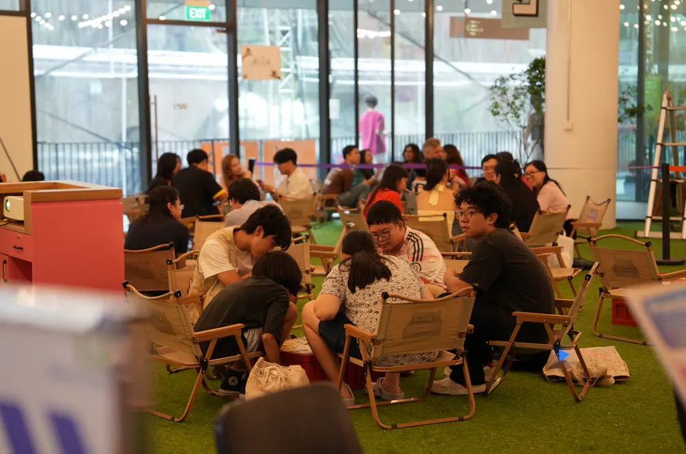 Friends talking in camp chairs on astroturf, Level 2