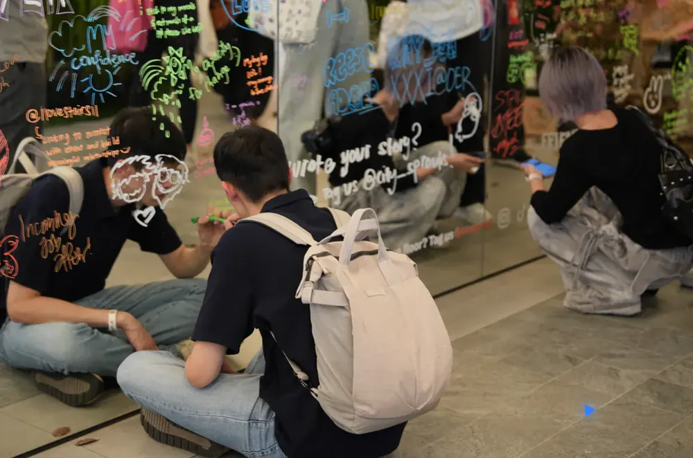 Someone sitting alone beneath the Wall of Words, Level 4
